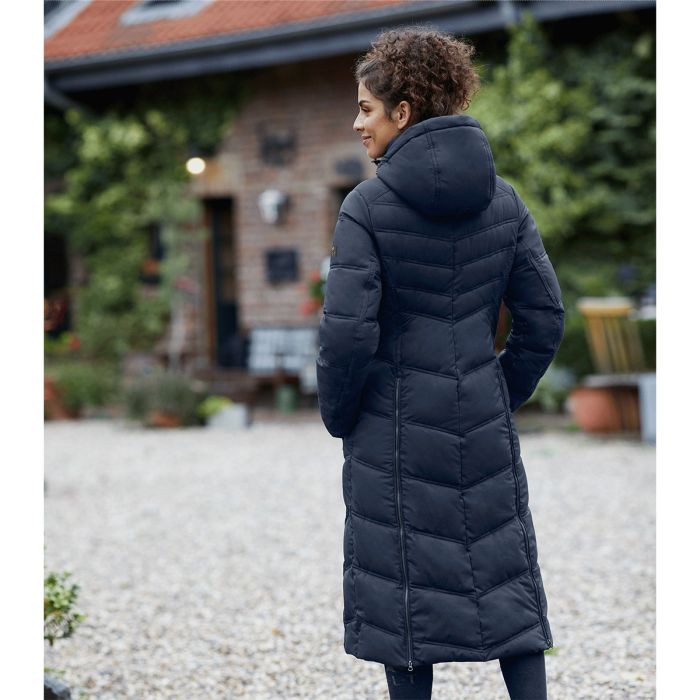 Woman wearing ELT Saphira Winter Ridingcoat jacket with hood, showcasing diagonal quilting and a stylish design outdoors.